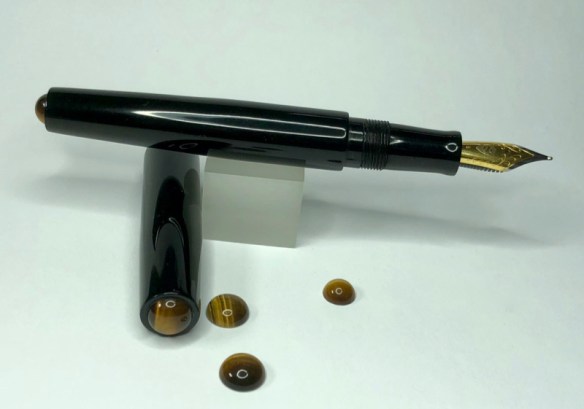 Illuminaire in Solid Black Ebonite with Tiger's Eye Cabochons - Small