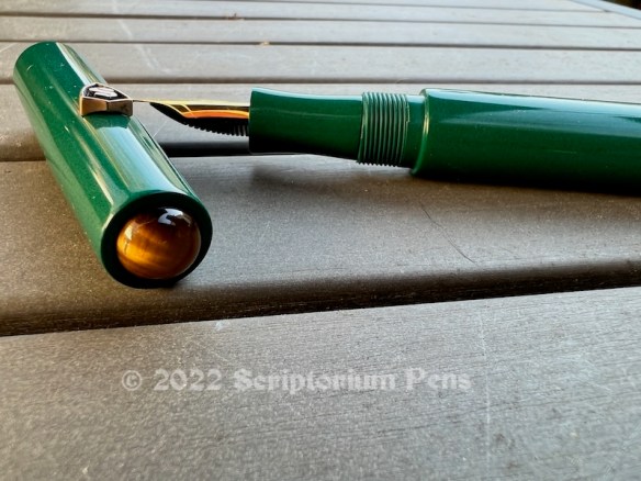 Illuminaire in Nikko Green Ebonite with Tiger’s Eye Cabochons and Bronze Large Shield Logo - Small